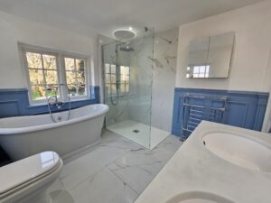 Bathroom 3.7 A white bathroom, with a shower, toilet and sink in Reading from Unique Solutions.