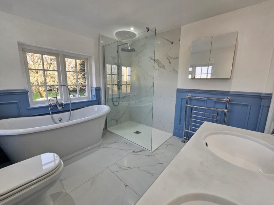 A white bathroom, with a shower, toilet and sink in Reading and Slough from Unique Solutions. 